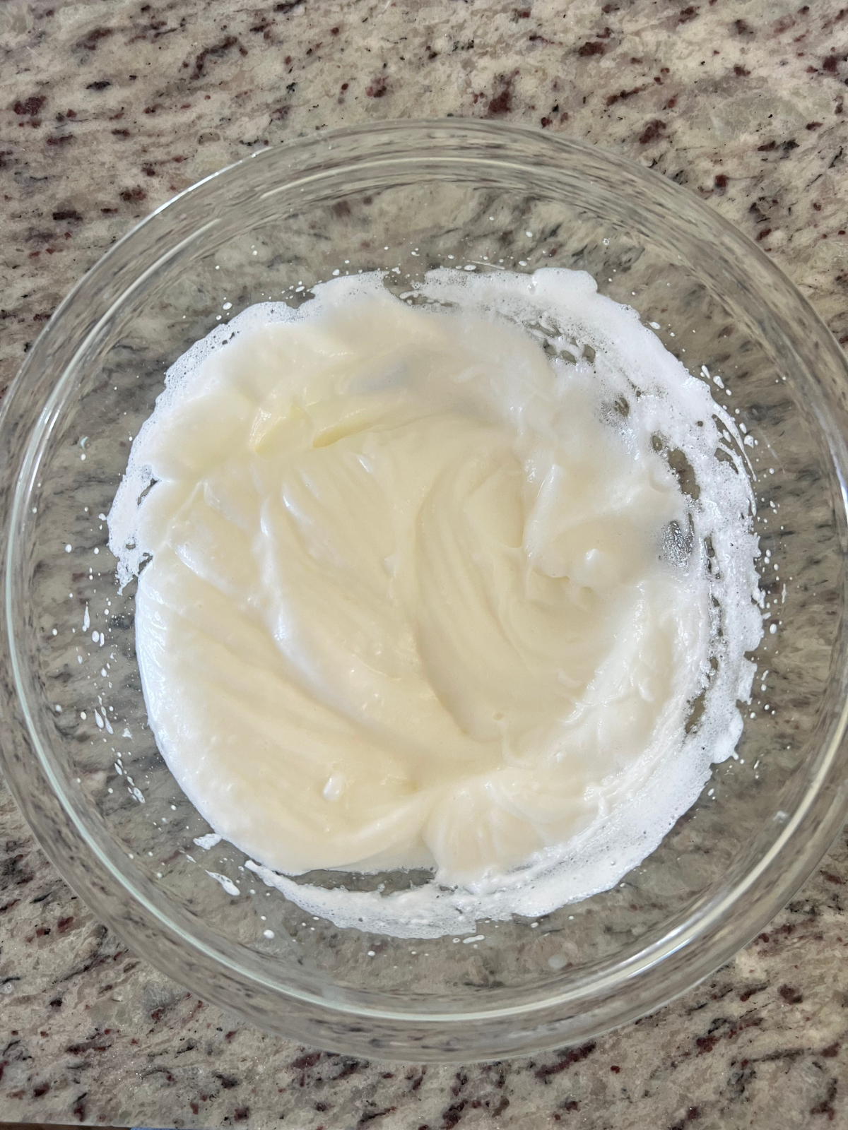 The egg whites have been beaten until soft peaks form.