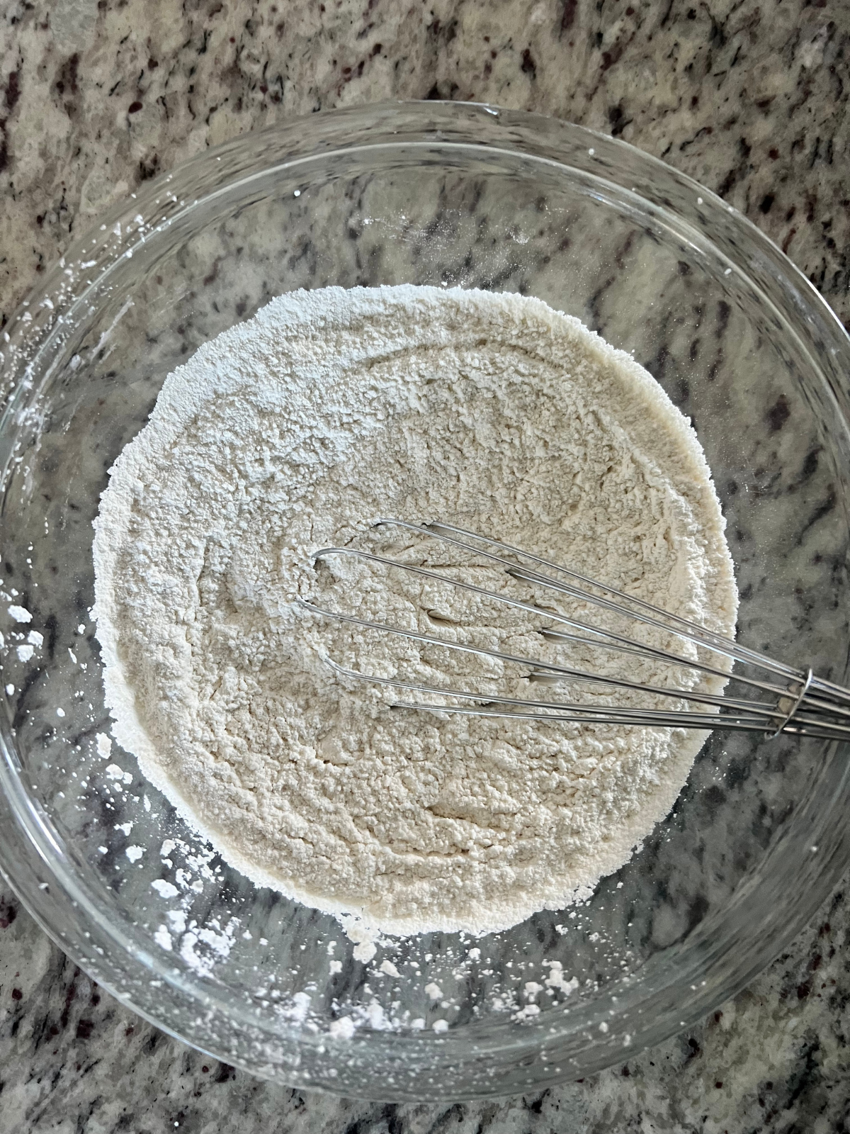 The dry ingredients sit in the bowl for the sourdough discard dot cakes.