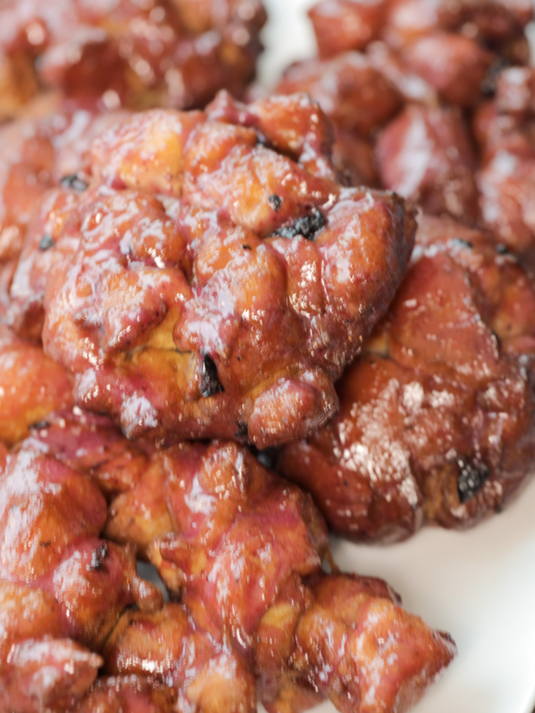 Homemade sourdough lemon blueberry fritters sit on a platter.