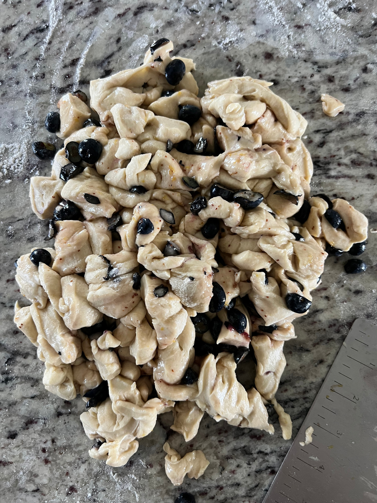 The lemon blueberry sourdough fritter dough has been chopped into small pieces to then be formed into fritters.