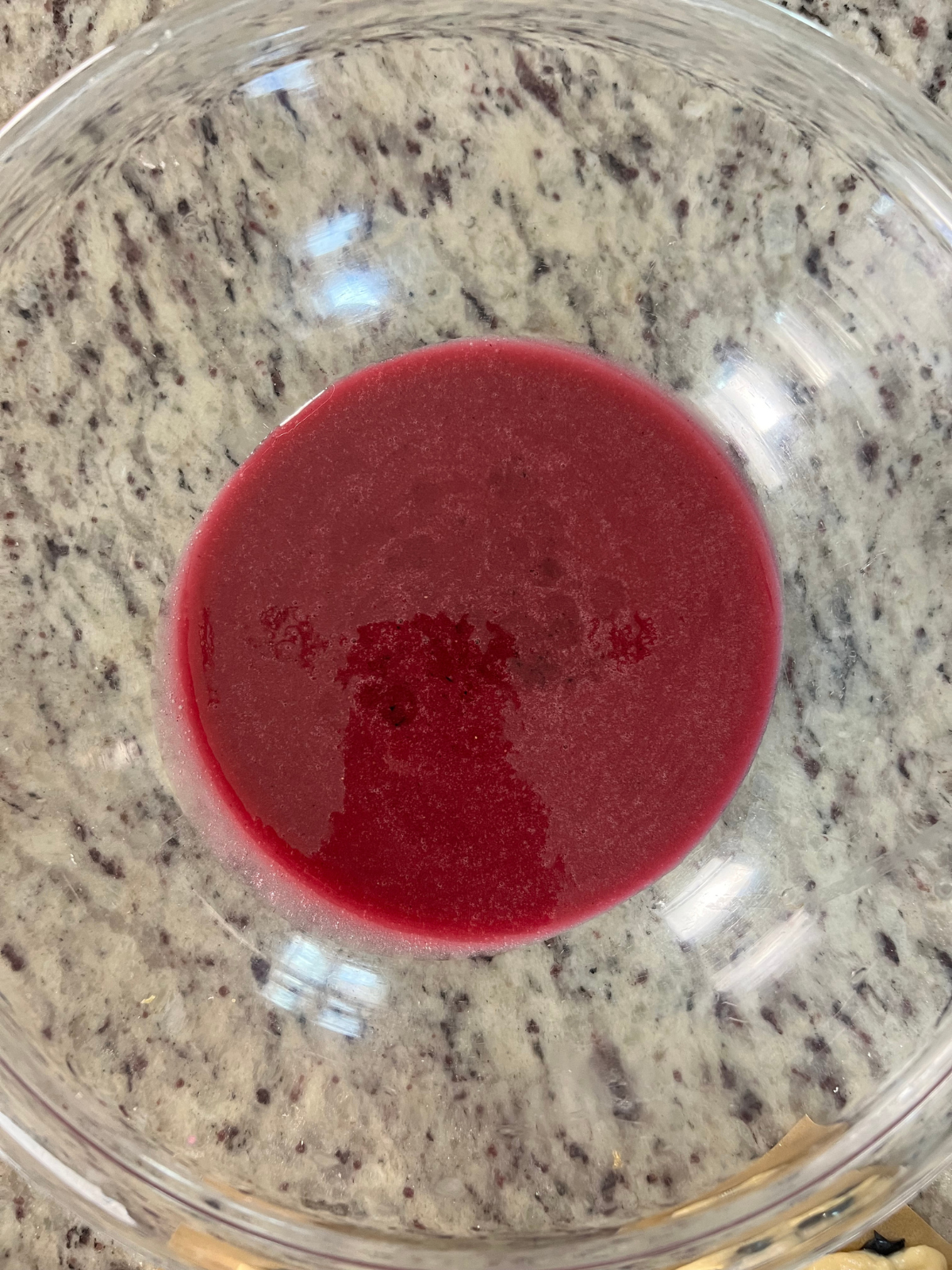 The strained lemon blueberry glaze is shown smooth and ready for dipping. 