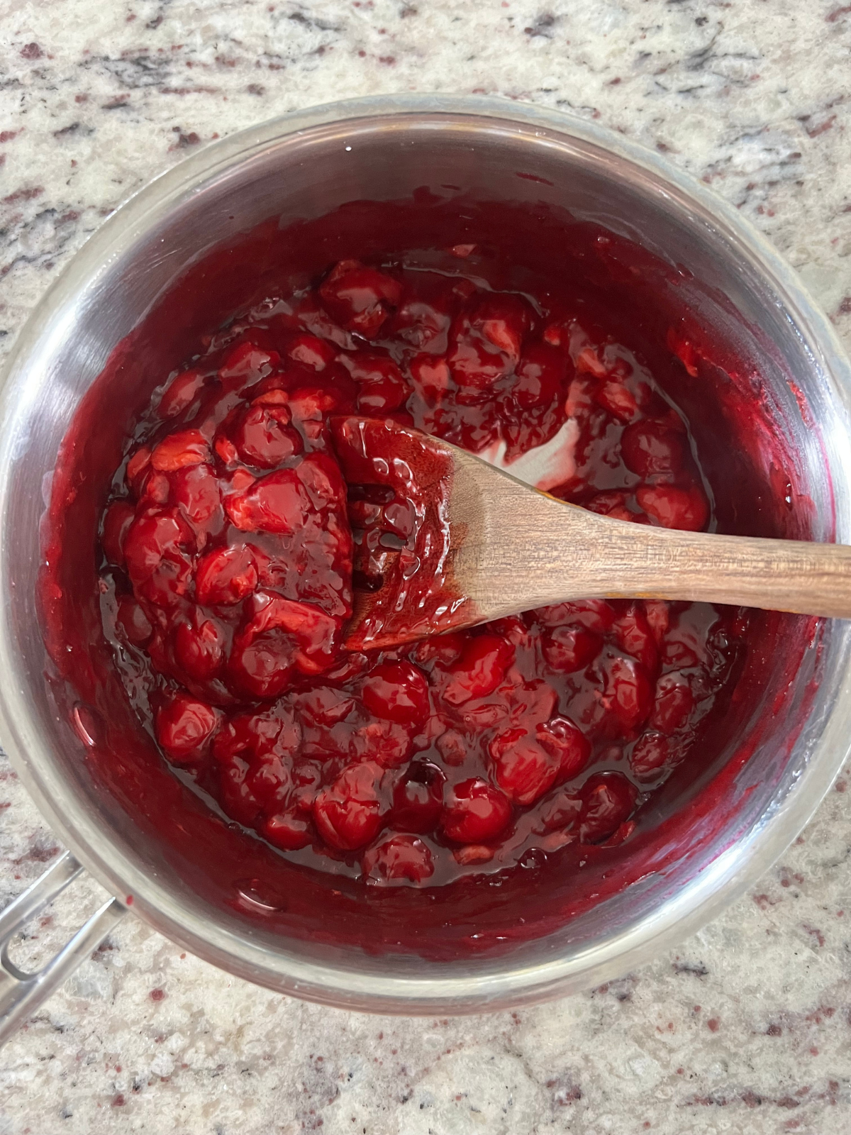 The cherry filling sits in a medium saucepan after cooking.