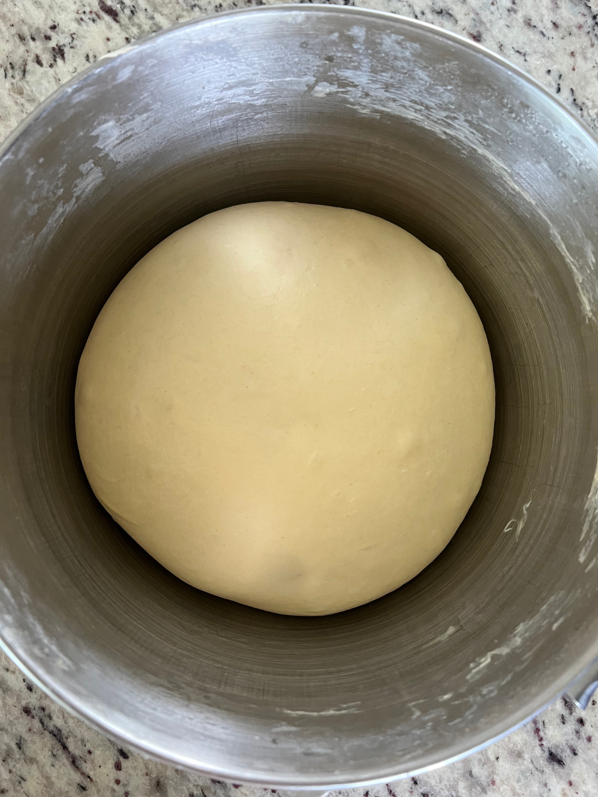 The sourdough brioche dough has risen and is ready to be divided and have its second rise.