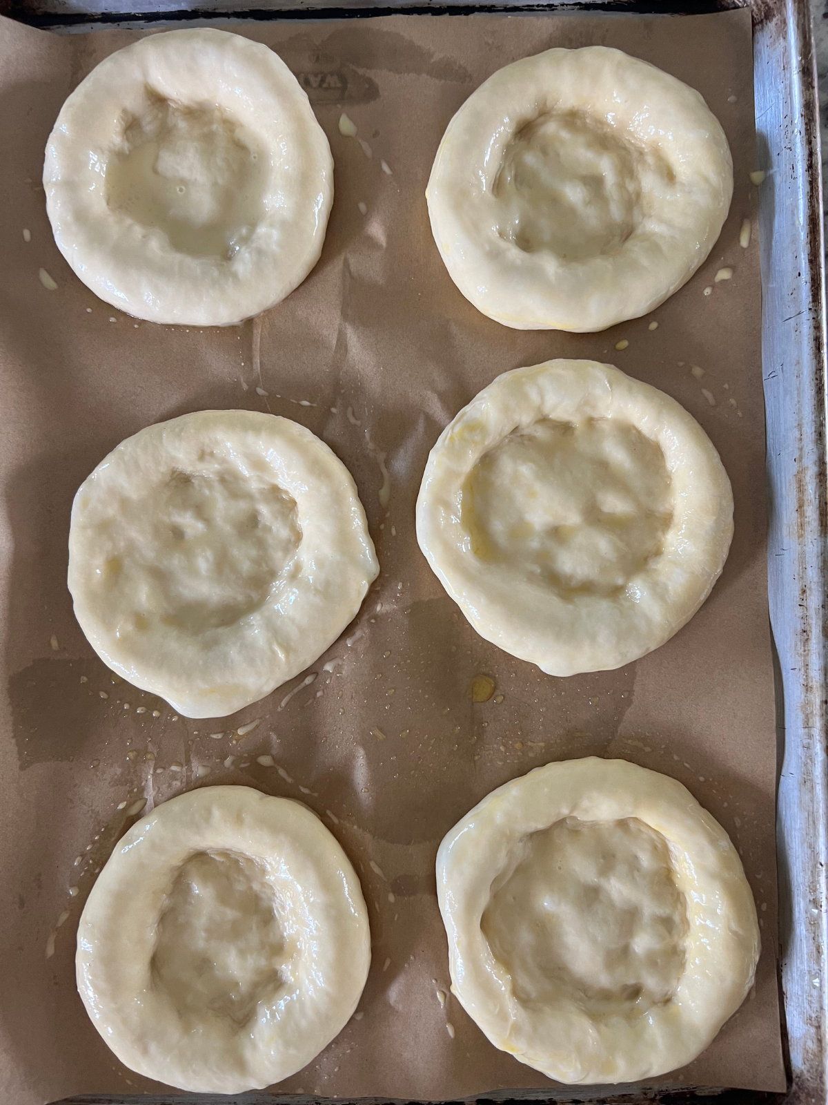 The sourdough brioche buns have been pressed down to make room for the fillings.