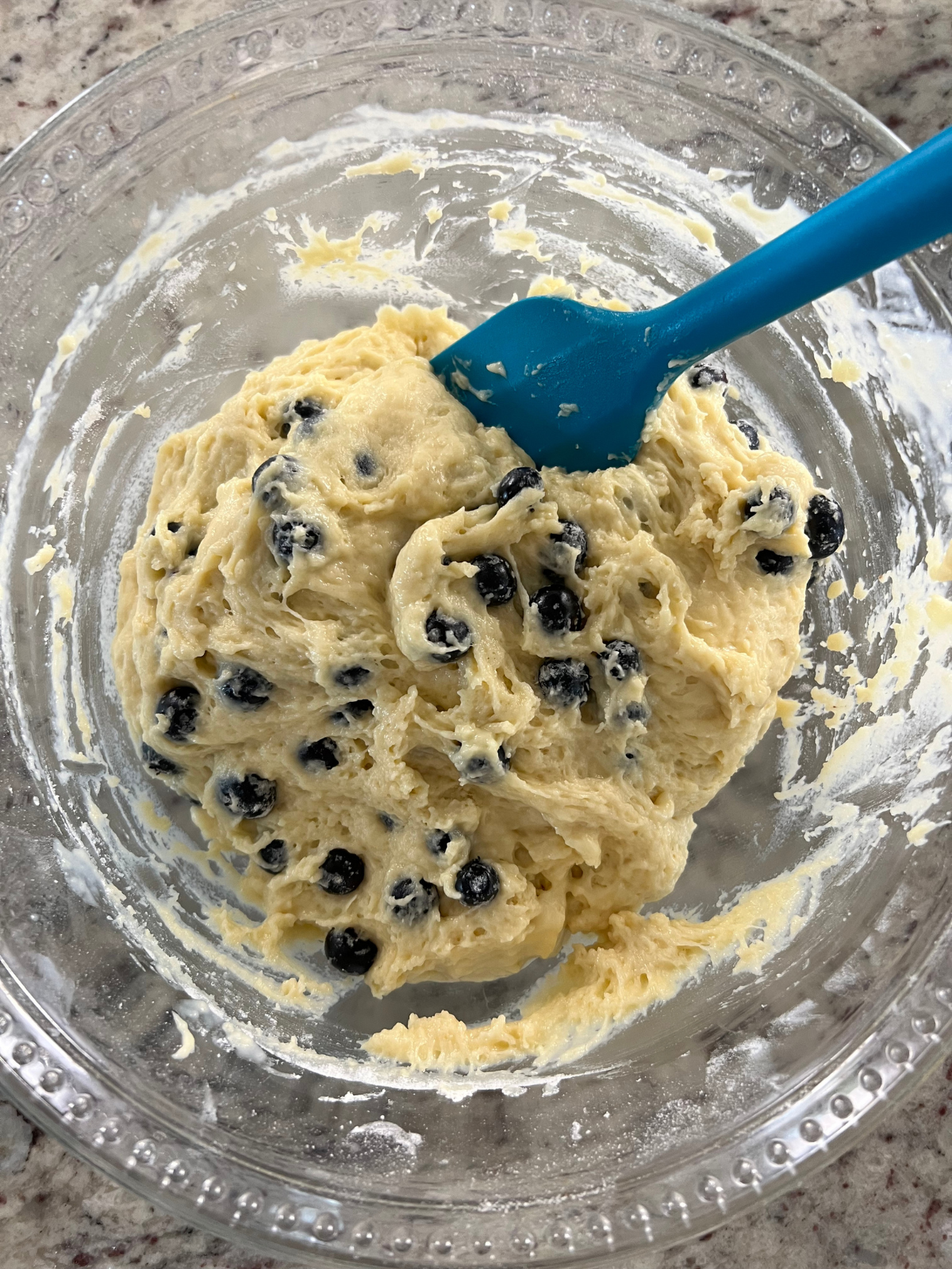 The batter for the sourdough discard blueberry loaf sit in a mixing bowl.