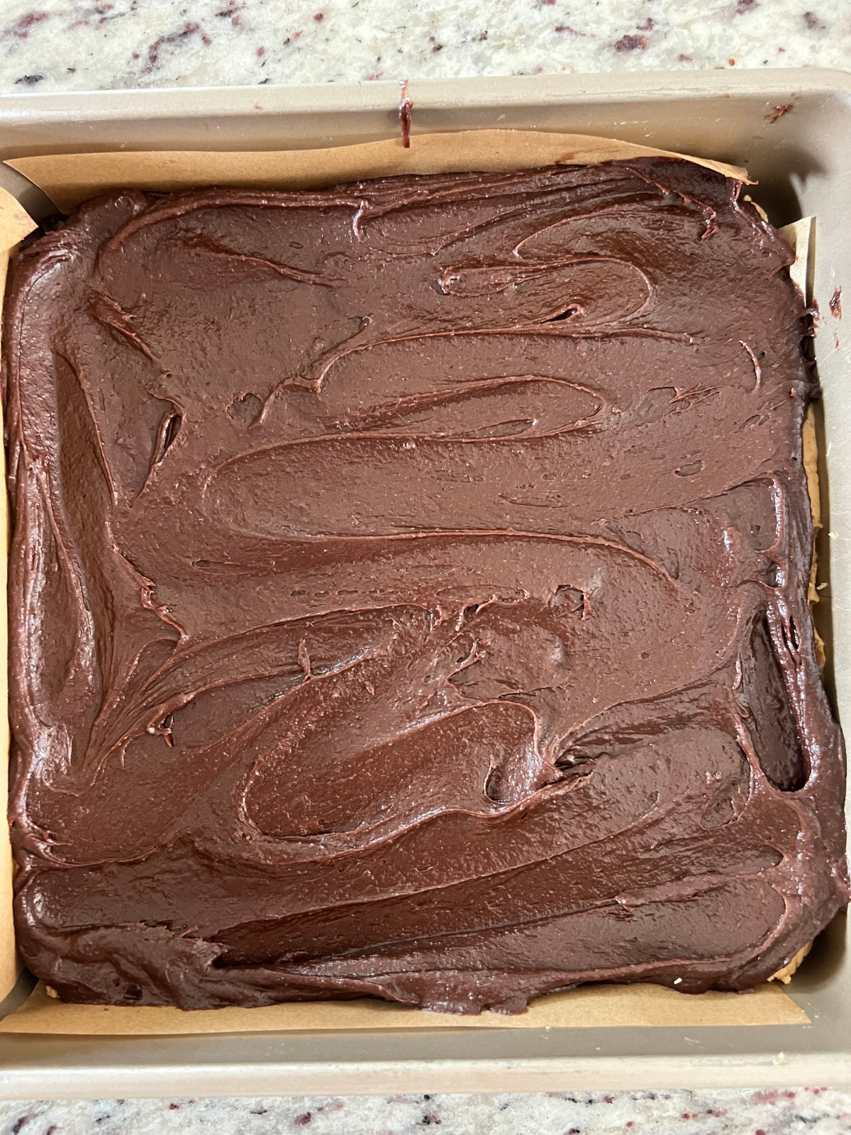 The remaining sourdough brownie batter is spread over the peanut butter filling.