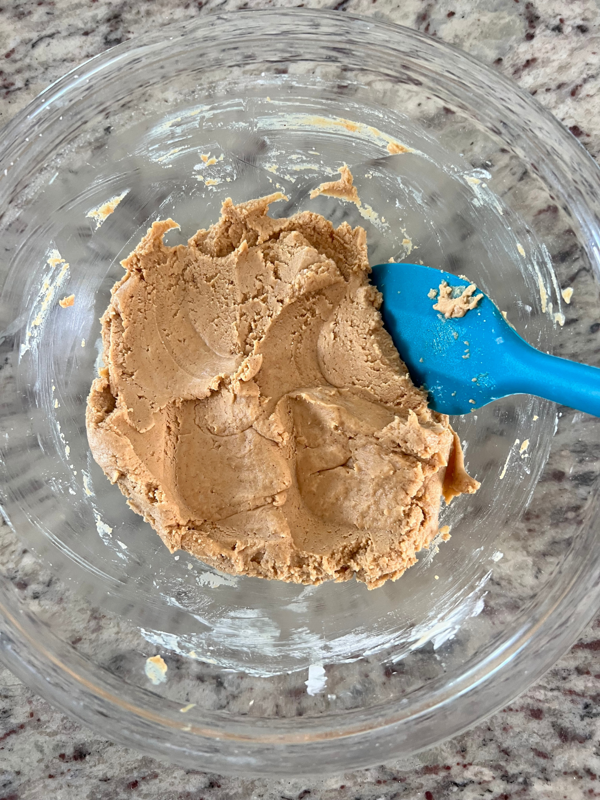 The peanut butter filling sits in a mixing bowl after being mixed together.