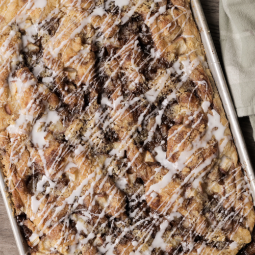 Full tray of sourdough peach crumble focaccia with vanilla icing.
