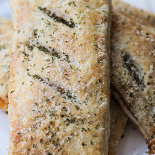 A closeup of a sourdough discard pepperoni pizza hot pocket fresh out of the oven.