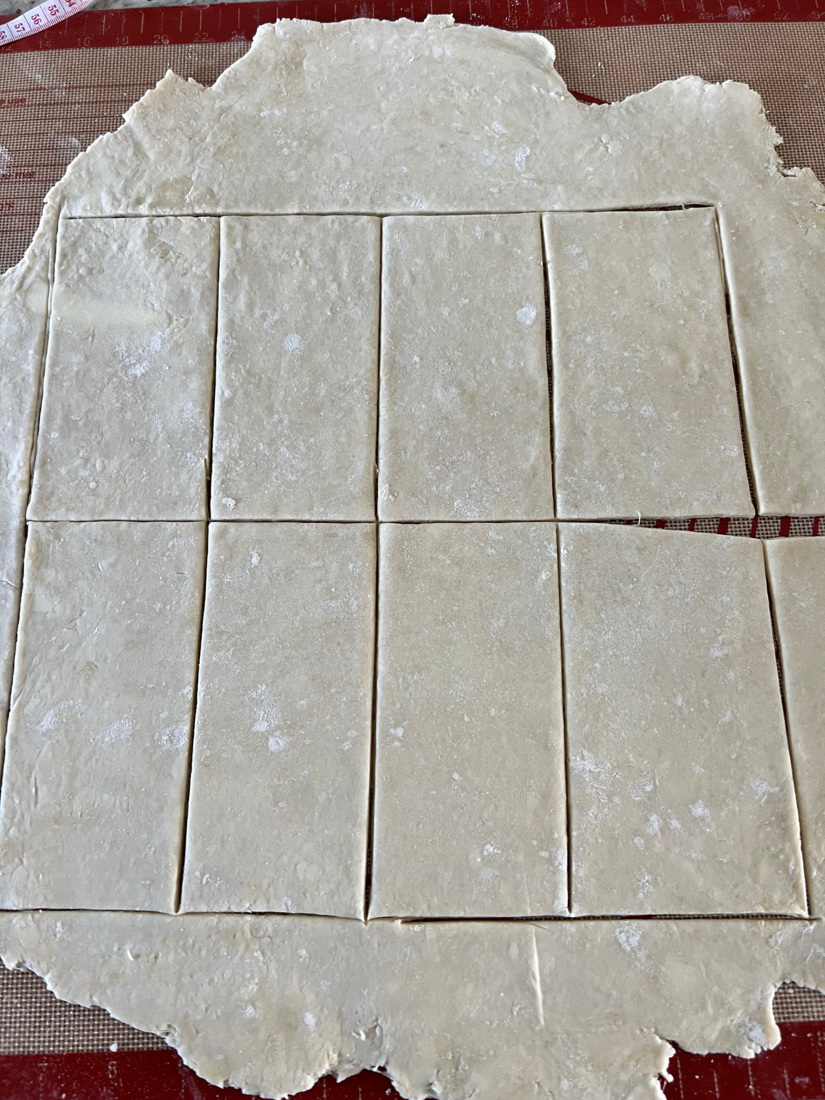 The sourdough discard dough has been rolled out and cut into rectangles.