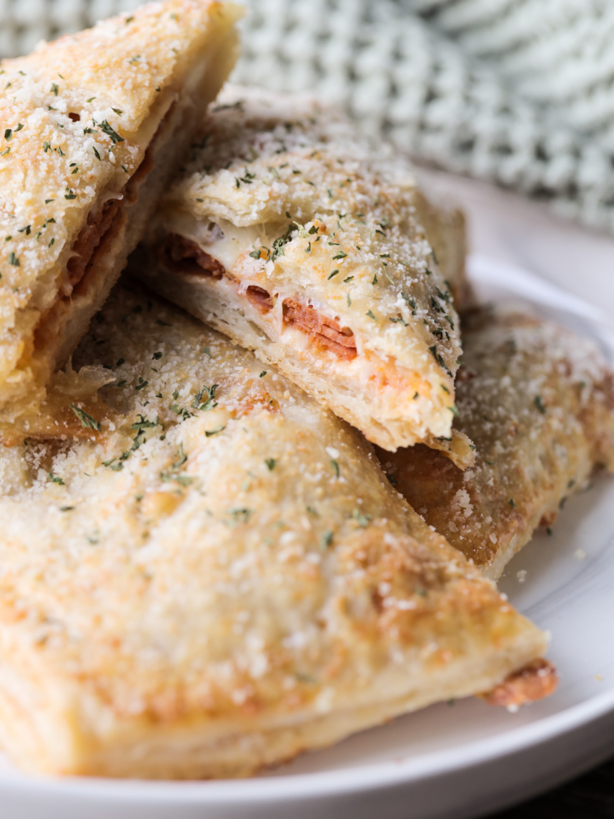 The sourdough pepperoni pizza hot pocket has been cut in half and the filling is shown.