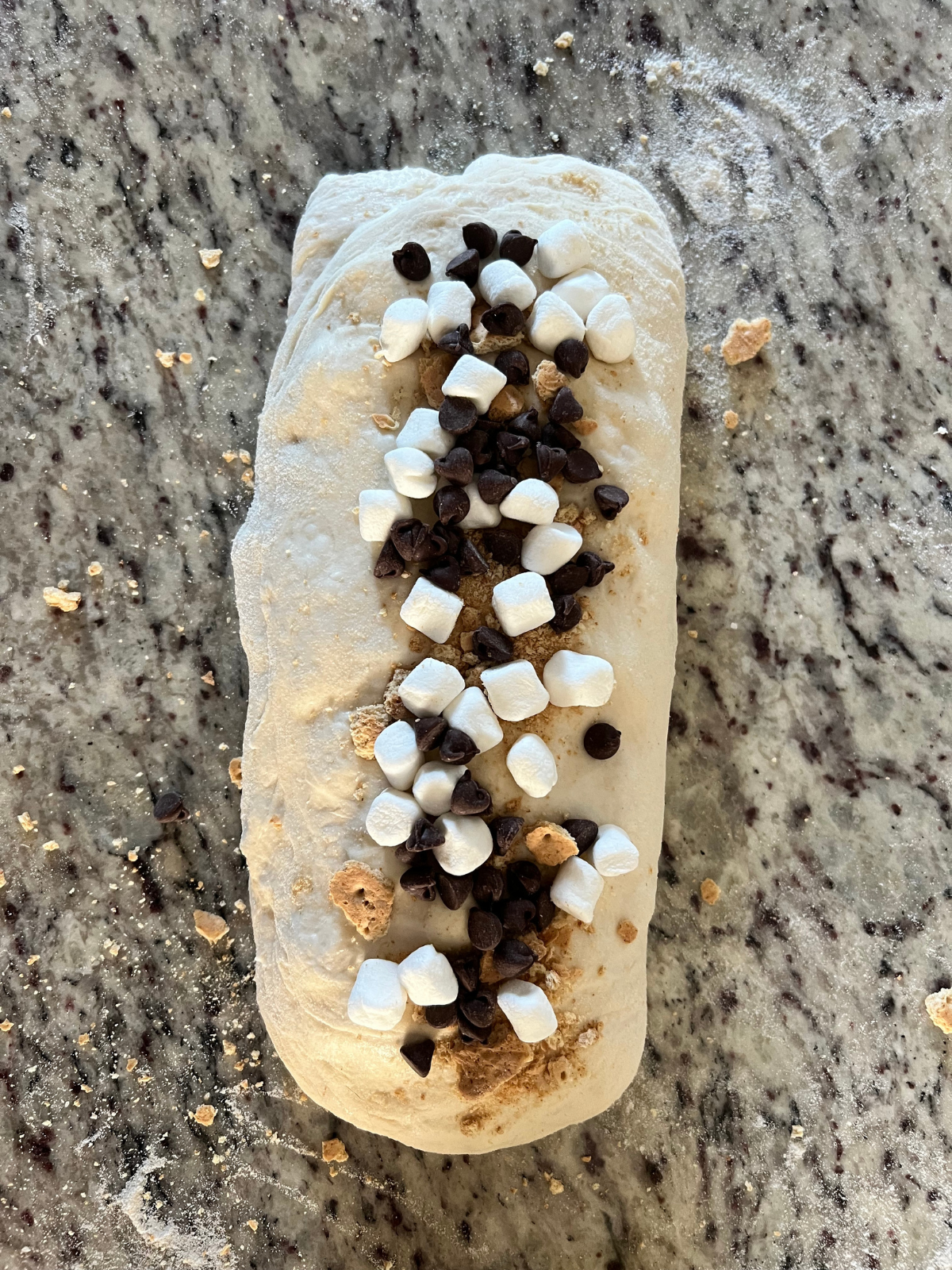 The sourdough smores dough has been folded into a log preparing for the final shaping.