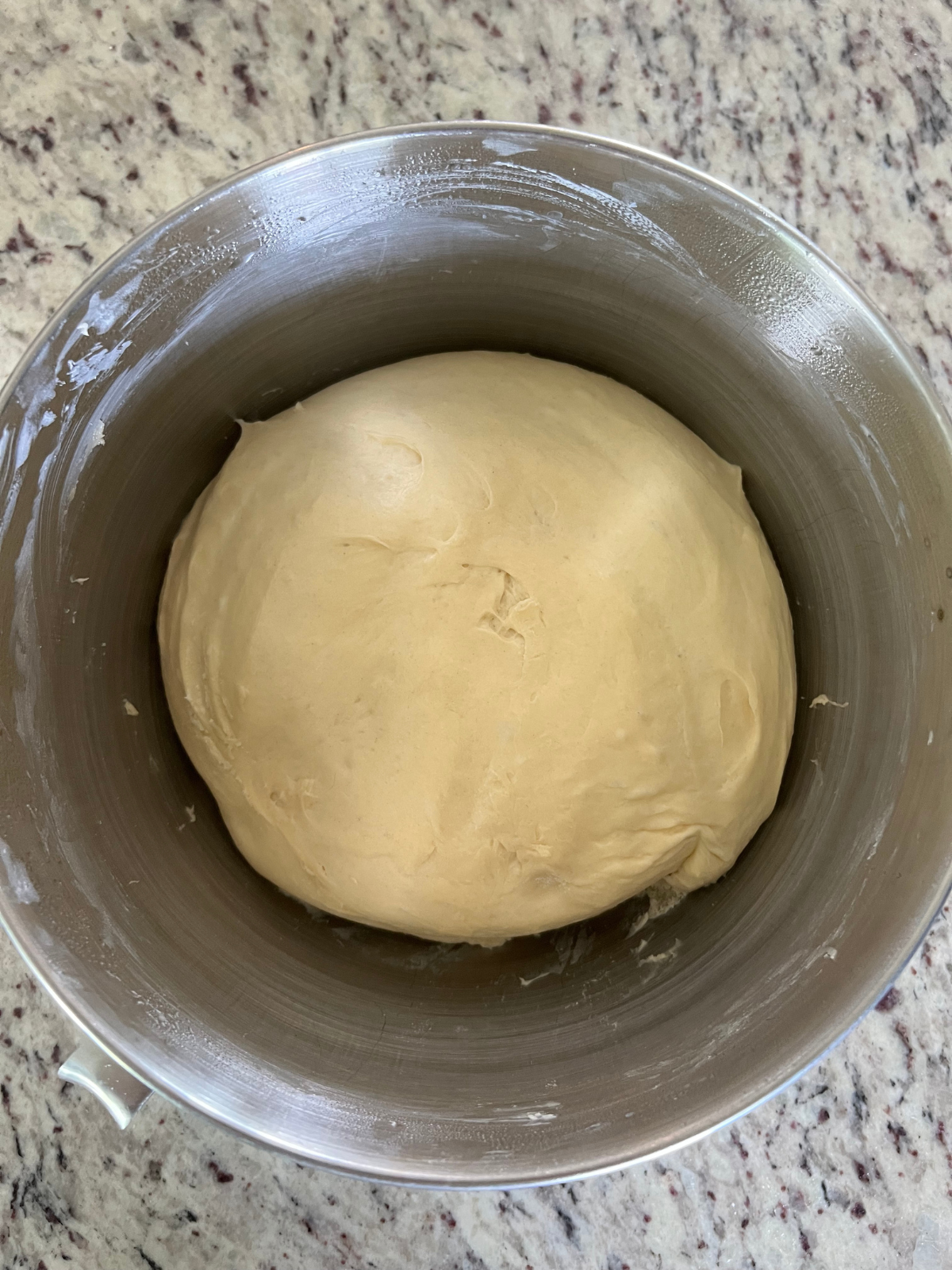 Sourdough brioche sweet roll dough has visibly risen and is fully fermented.