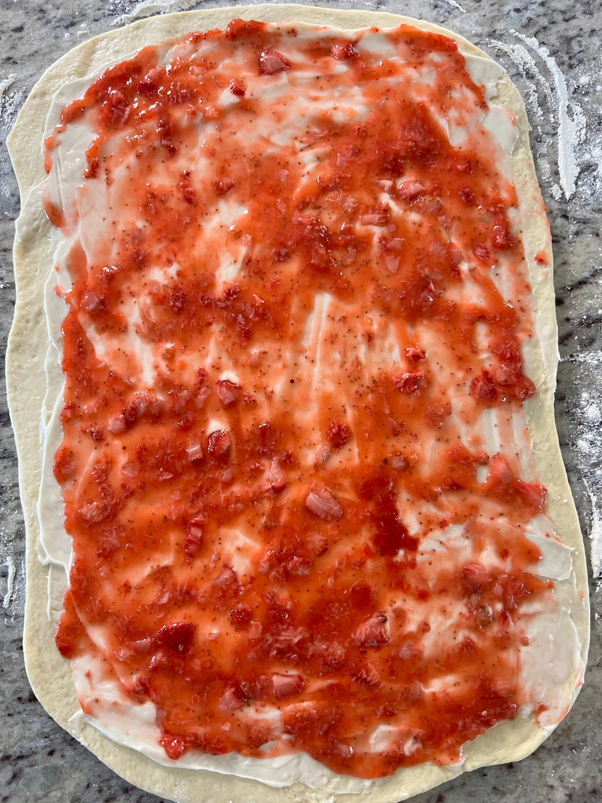 The filling has been spread over the sourdough sweet roll dough.