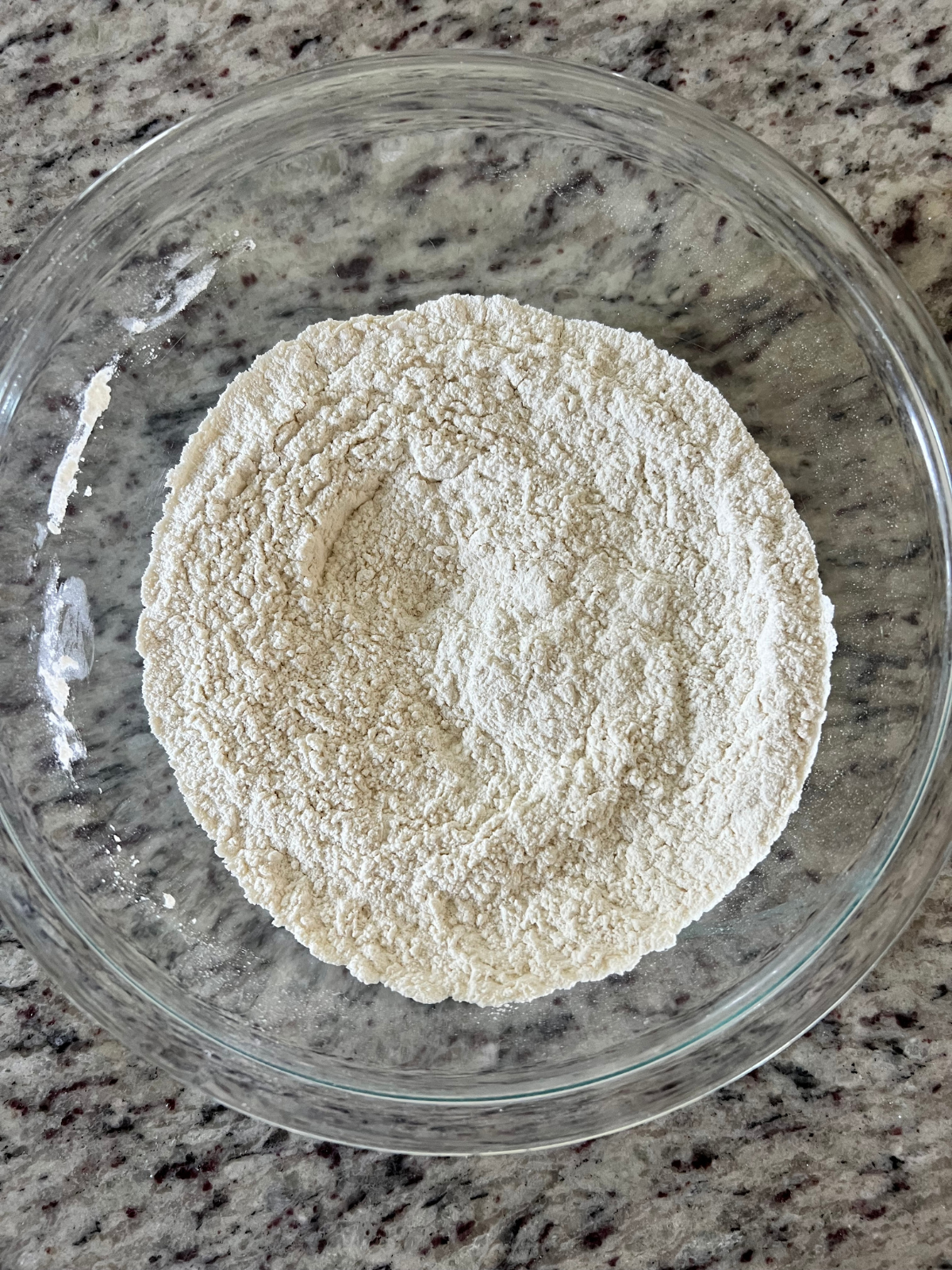 The dry ingredients for the sourdough discard sugar cookie crust rest in a mixing bowl. 