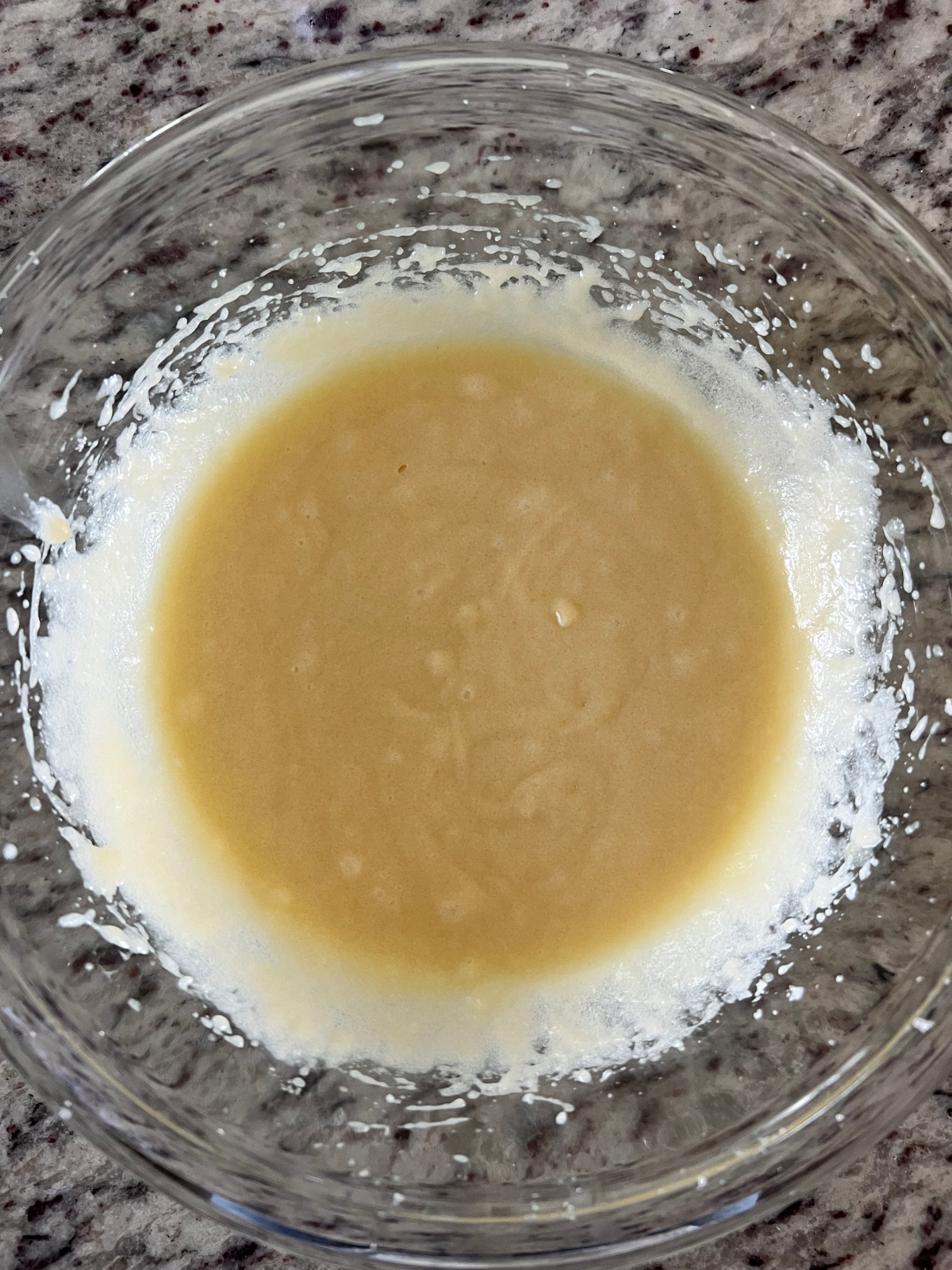 The wet ingredients for the sourdough discard sugar cookie crust rest in a mixing bowl. 