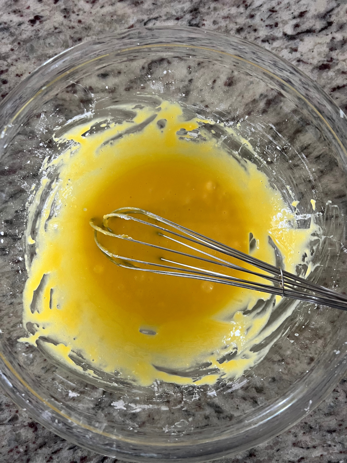 The egg and cornstarch is shown whisked in a mixing bowl--the first step to making the chocolate custard.
