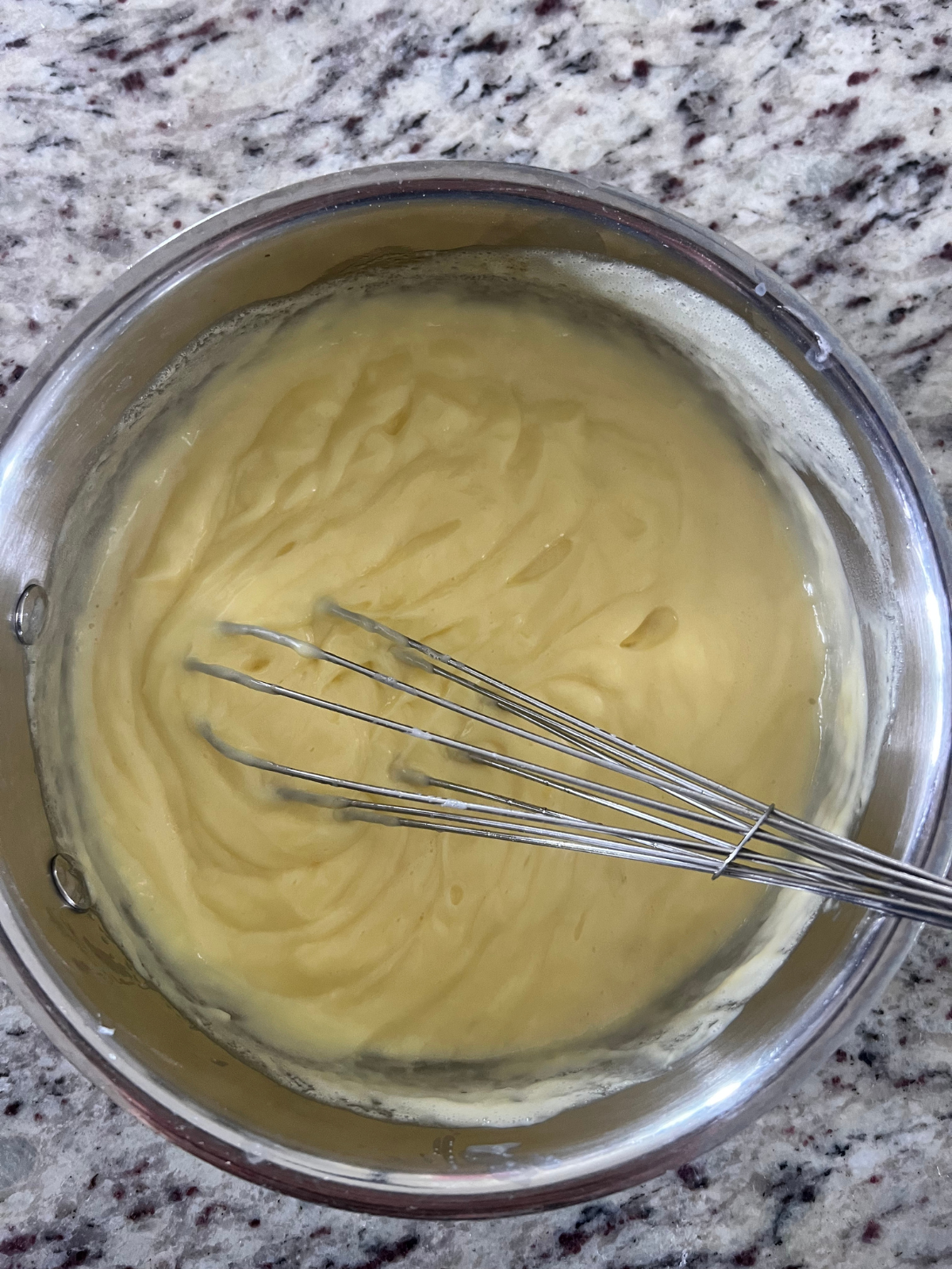 The custard is shown in the saucepan before the chocolate melting wafers have been added.