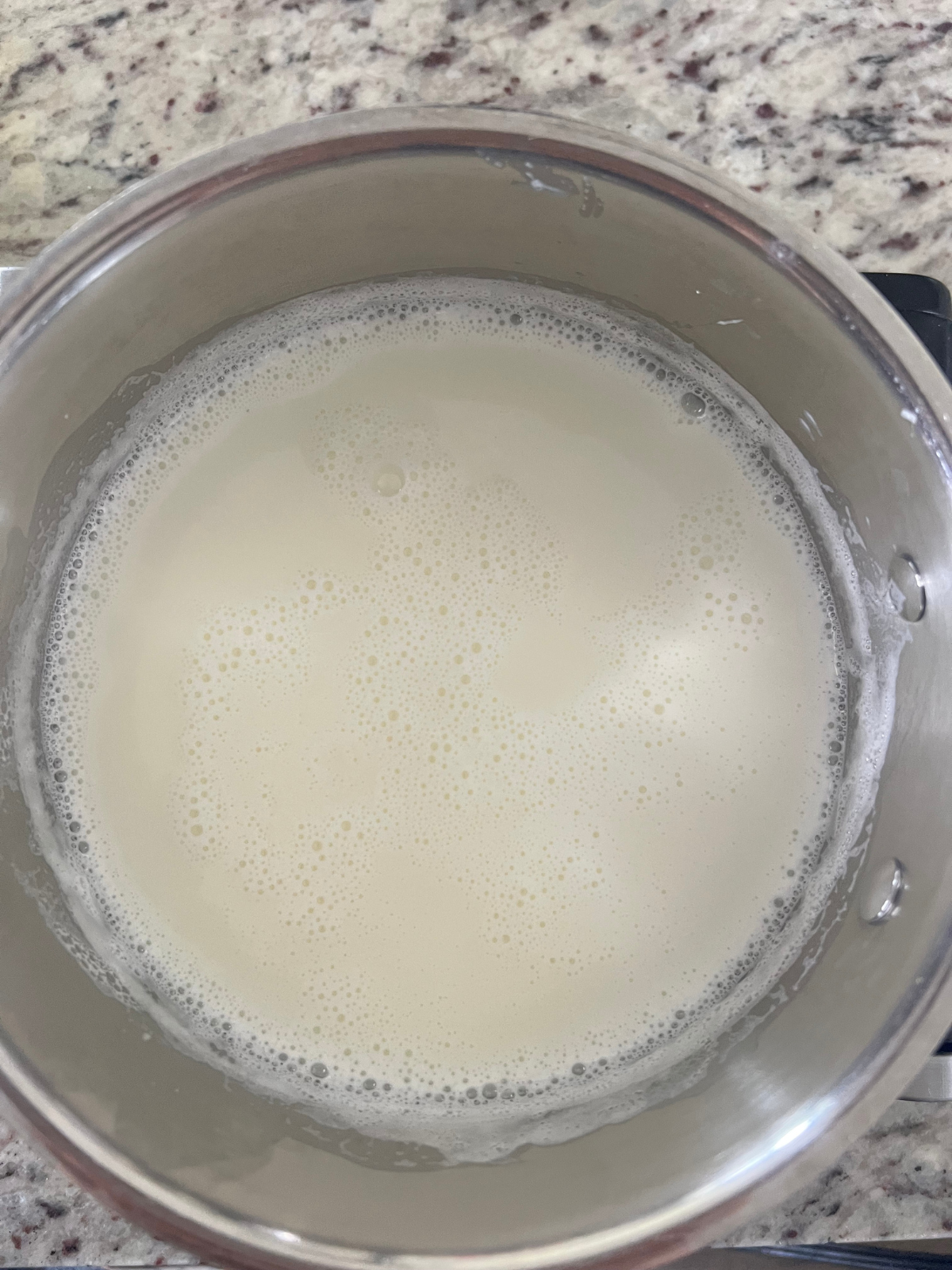 The milk mixture for the chocolate custard is shown heating up on the stove.
