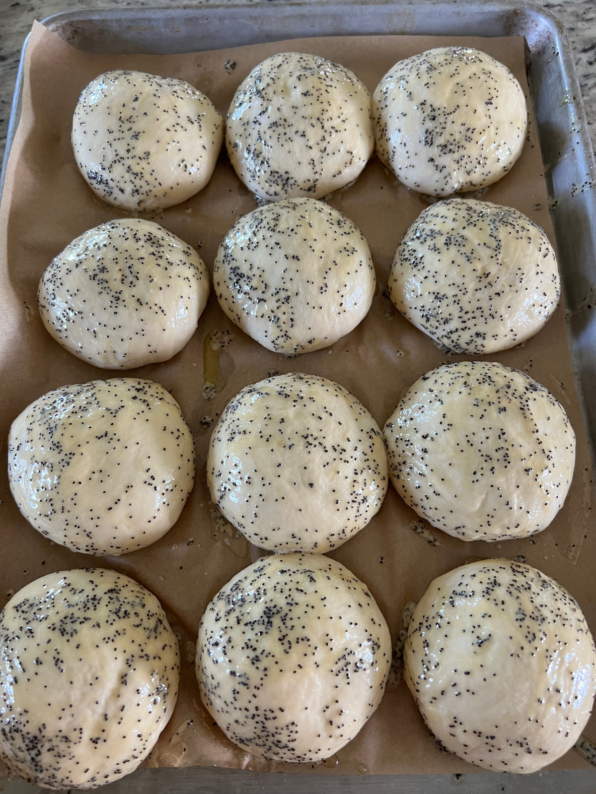 The sourdough ham and cheese pockets have completed their second rise and have been brushed with the Dijon butter spread.