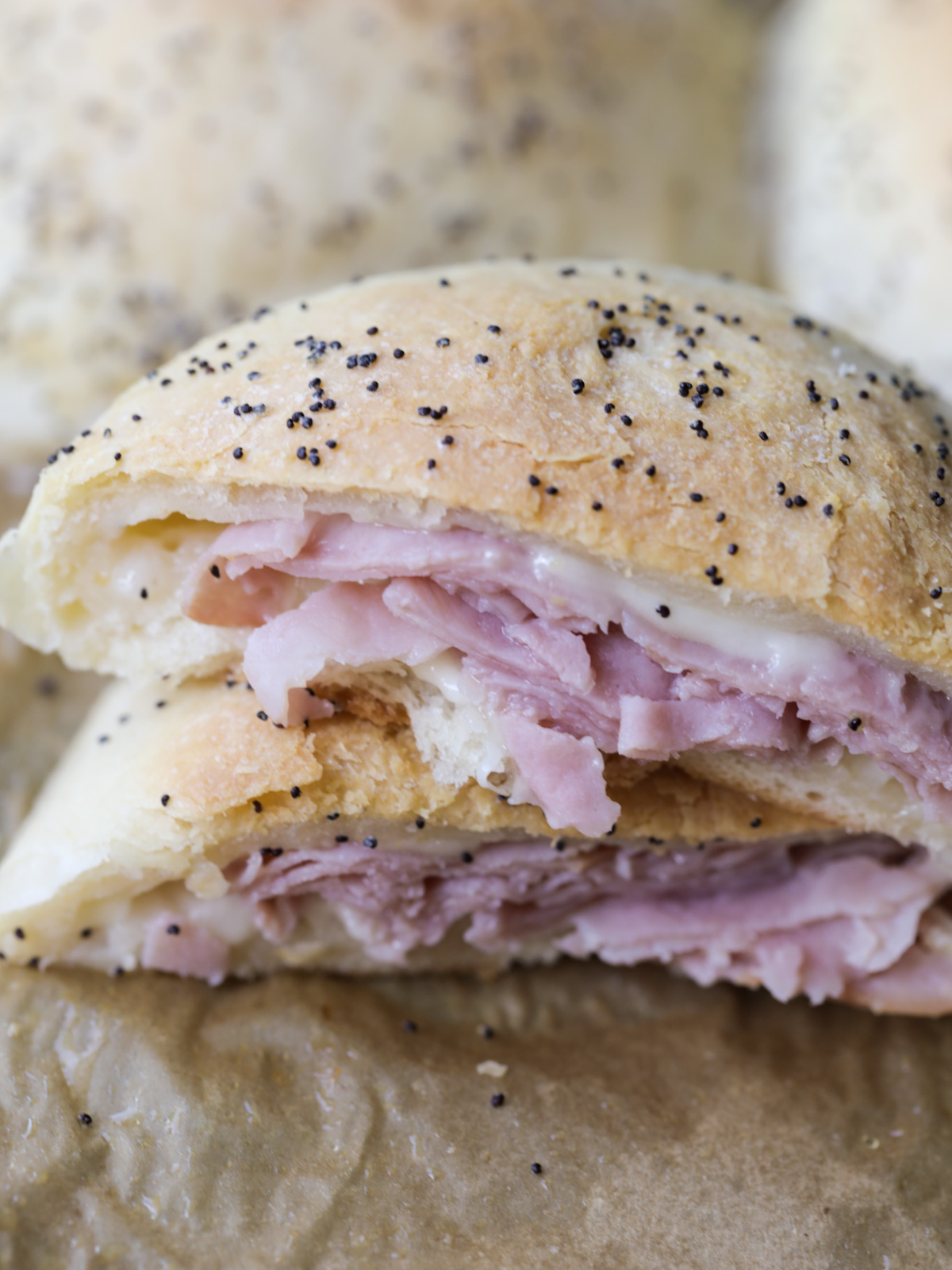 A closeup is shown of the sourdough filled ham and Swiss cheese pocket cut in half.