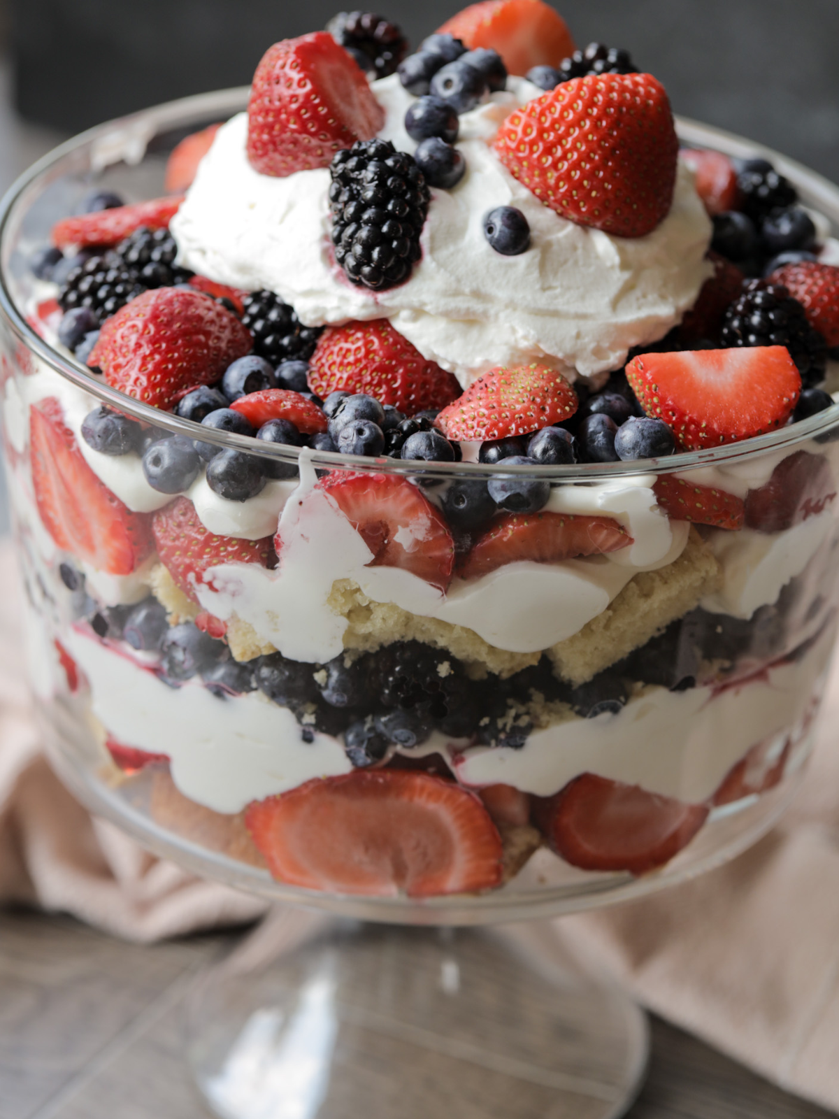 A closeup of the sourdough vanilla pound cake mixed berry trifle is shown. You can see the strawberries, blueberries, raspberries, and blackberries up close.