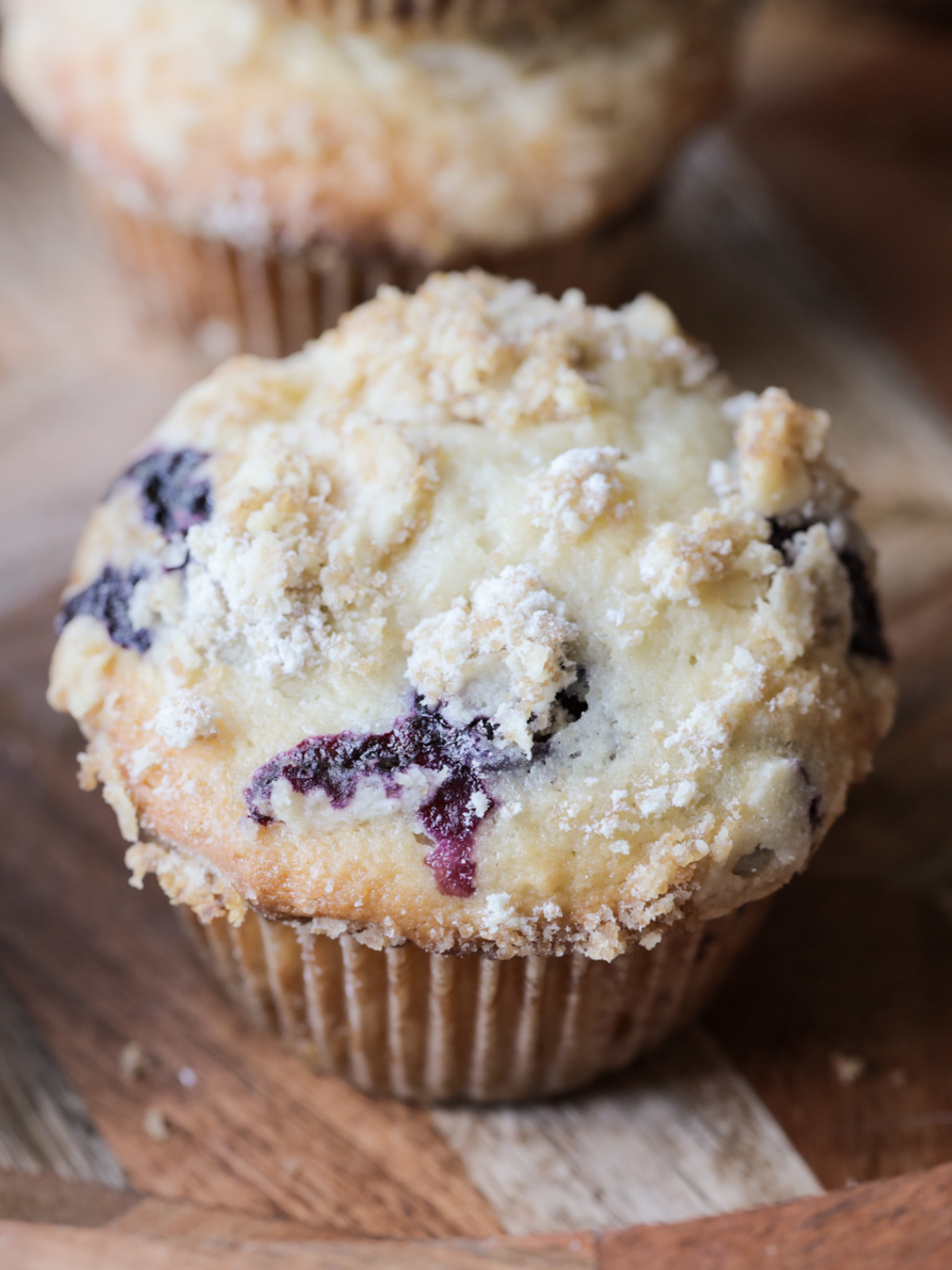 A closeup of the sourdough discard blueberry muffins topped with the brown sugar crumble.