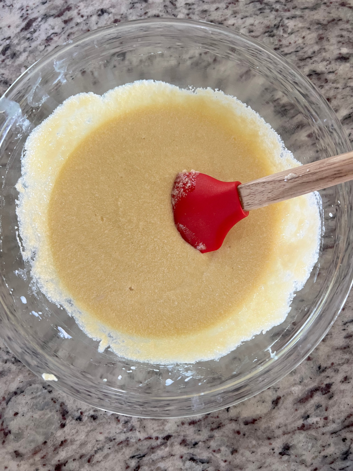 The wet ingredients sit in a glass mixing bowl for the sourdough discard vanilla pound cake.