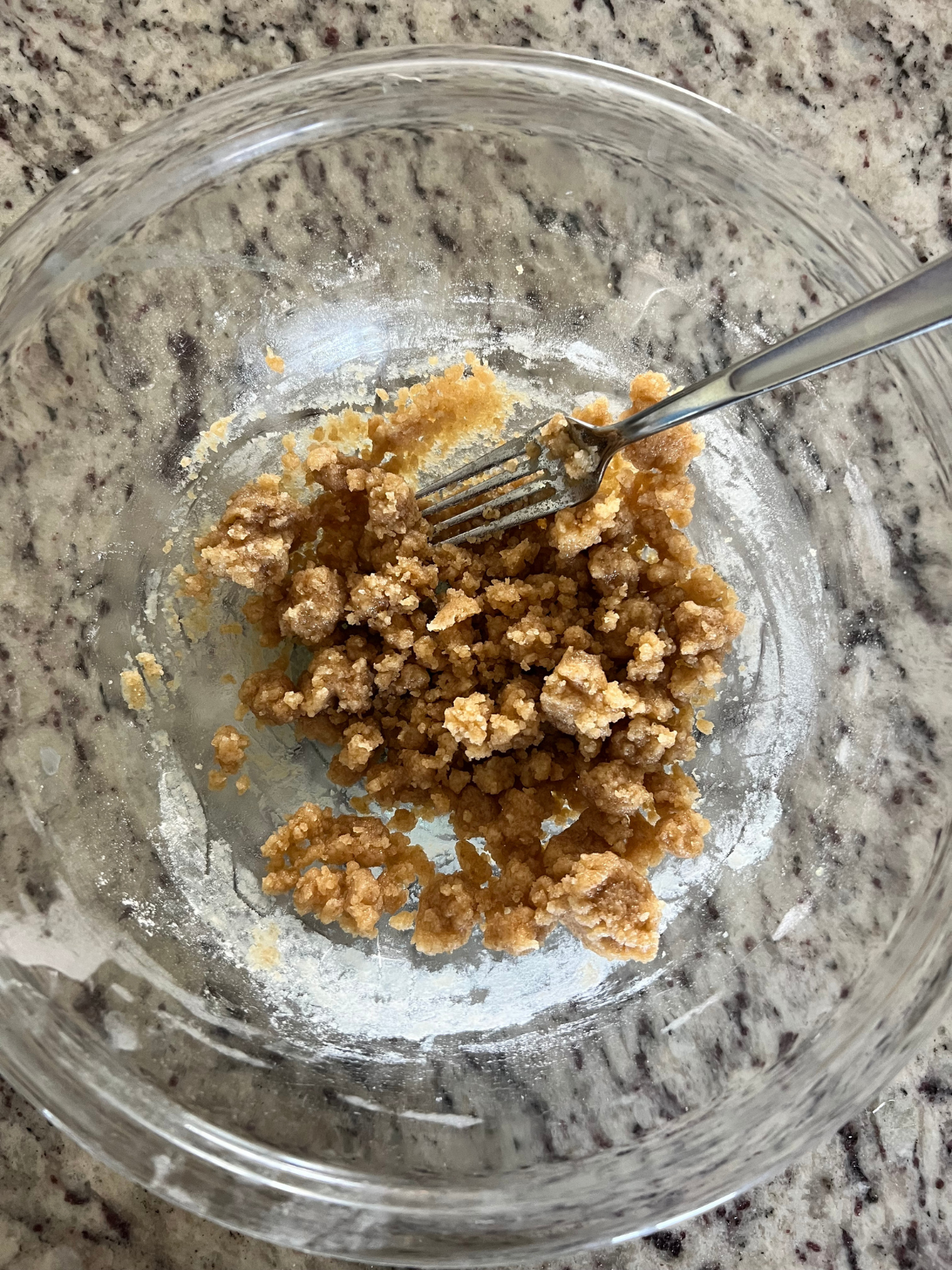 Homemade crumble to top sourdough desserts with is shown in a glass mixing bowl.