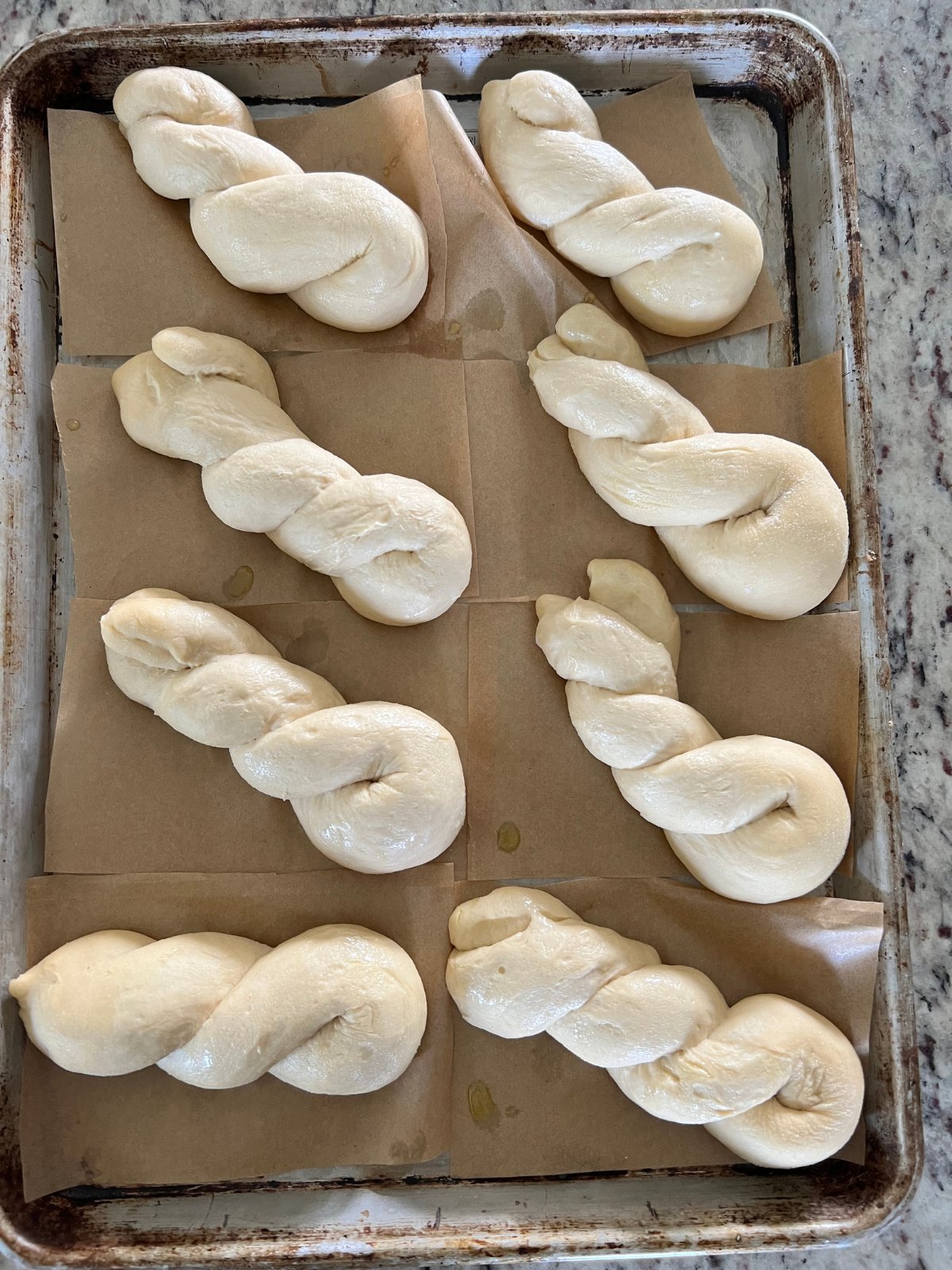 The shaped sourdough donuts are shown after their second rise, noticeably more puffy.