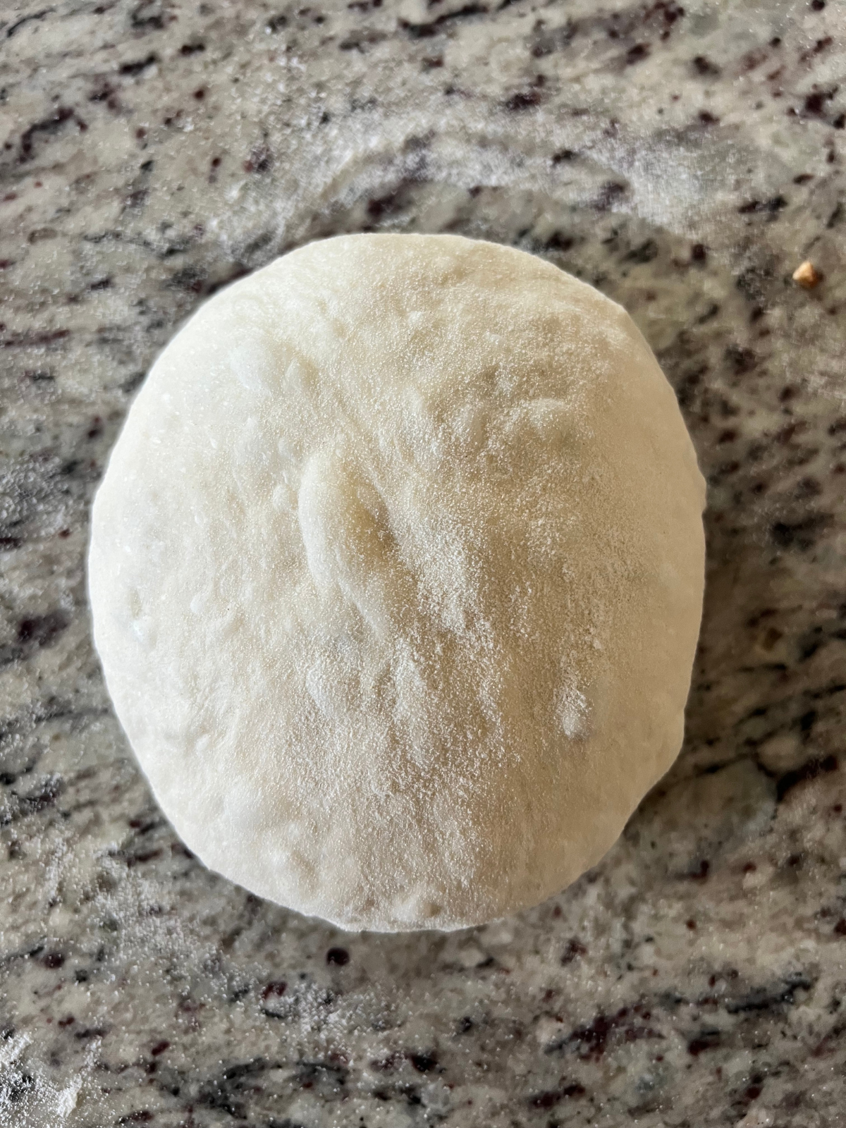 The dough has been rolled into a round ball. 