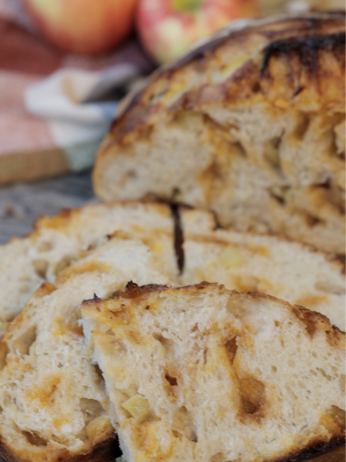 A closeup of the sourdough apple cider butterscotch bread slices where you can see the chopped apples and melty butterscotch. 
