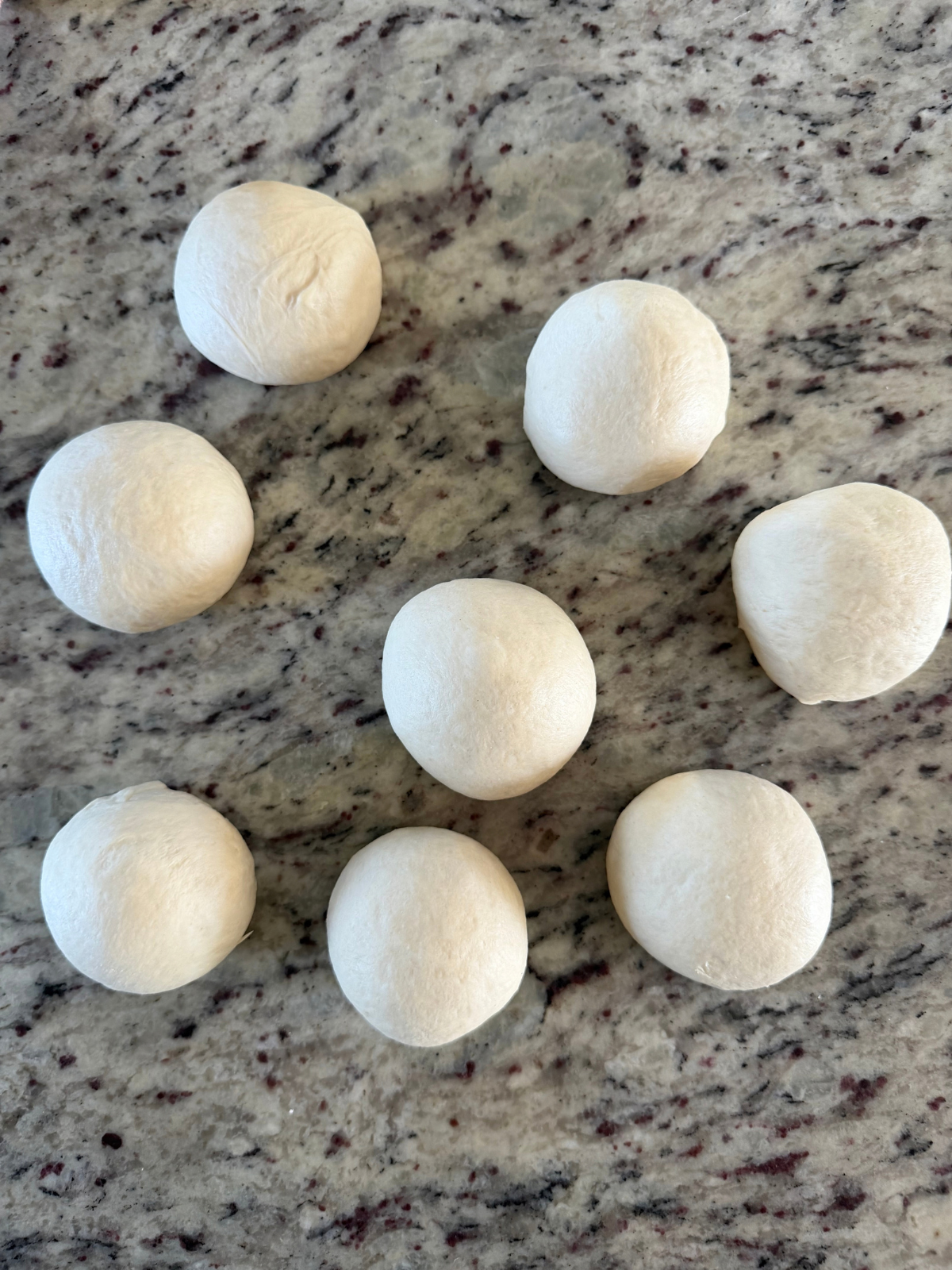 The sourdough discard naan dough balls have been divided. They will rest and then be shaped.
