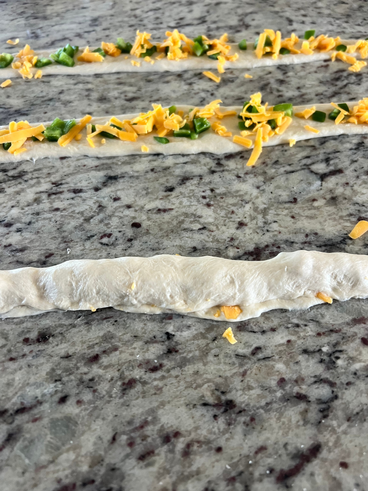 The dough rope is shown mid seam pressing. 