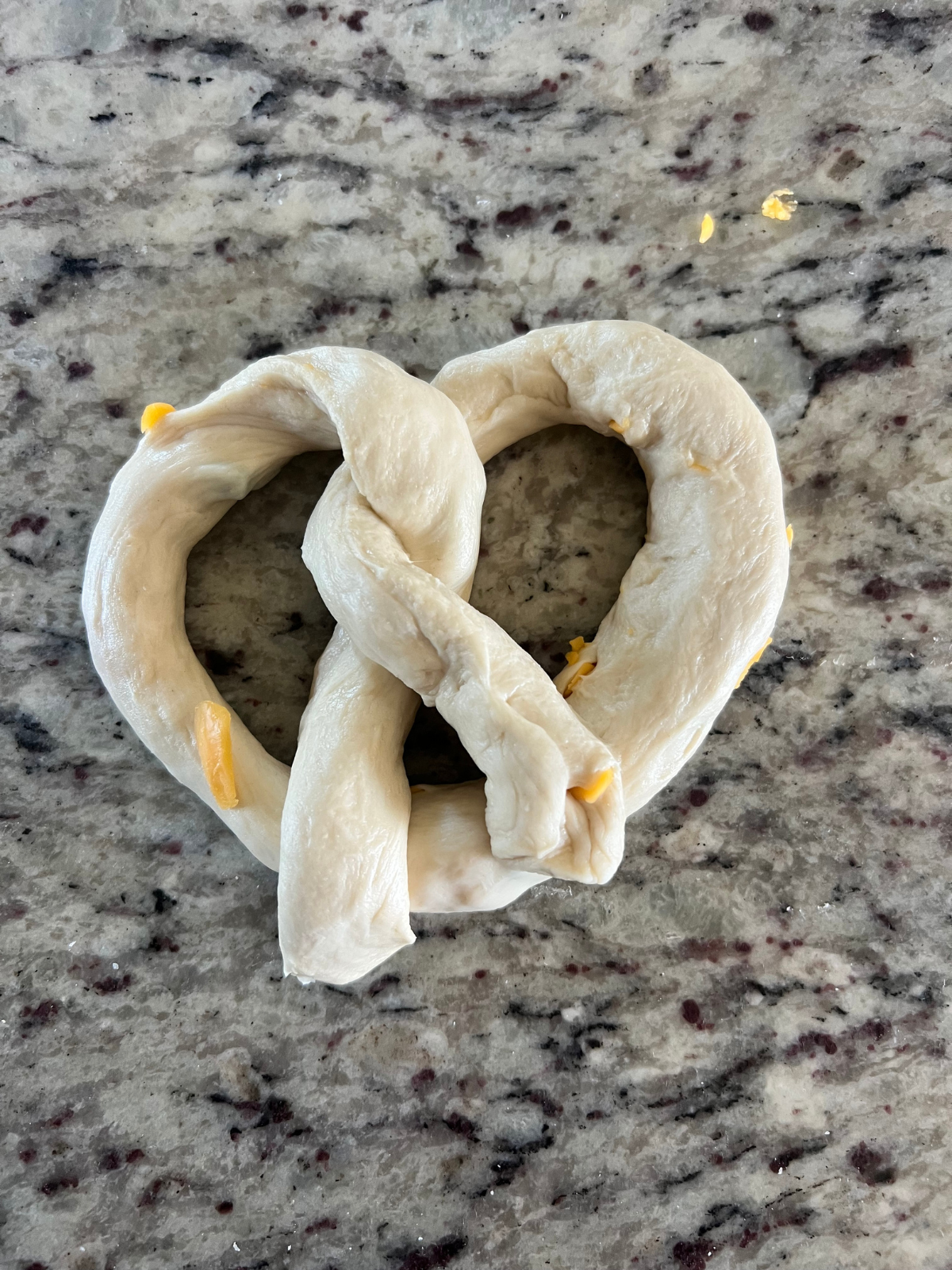 The sourdough jalapeno and cheddar pretzel is shown shaped awaiting its second rise.