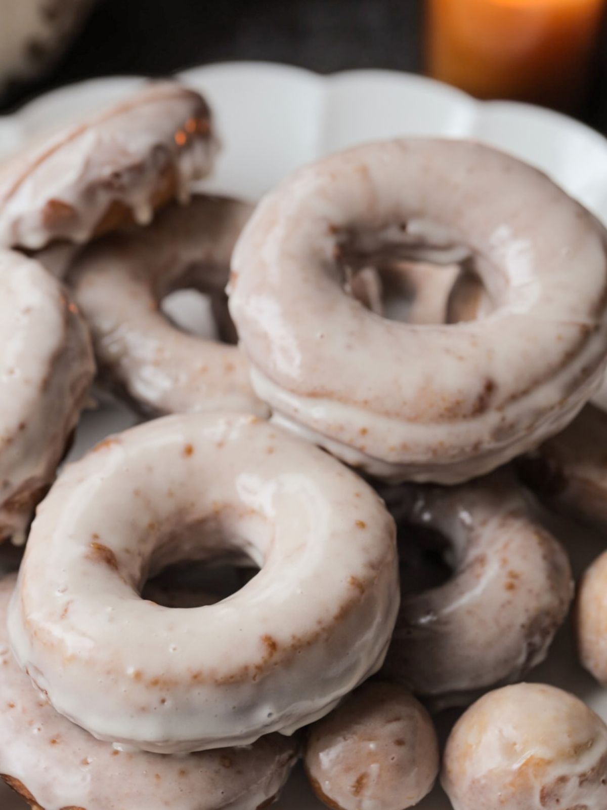 A closeup of the sourdough brioche pumpkin donuts with maple glaze is shown.