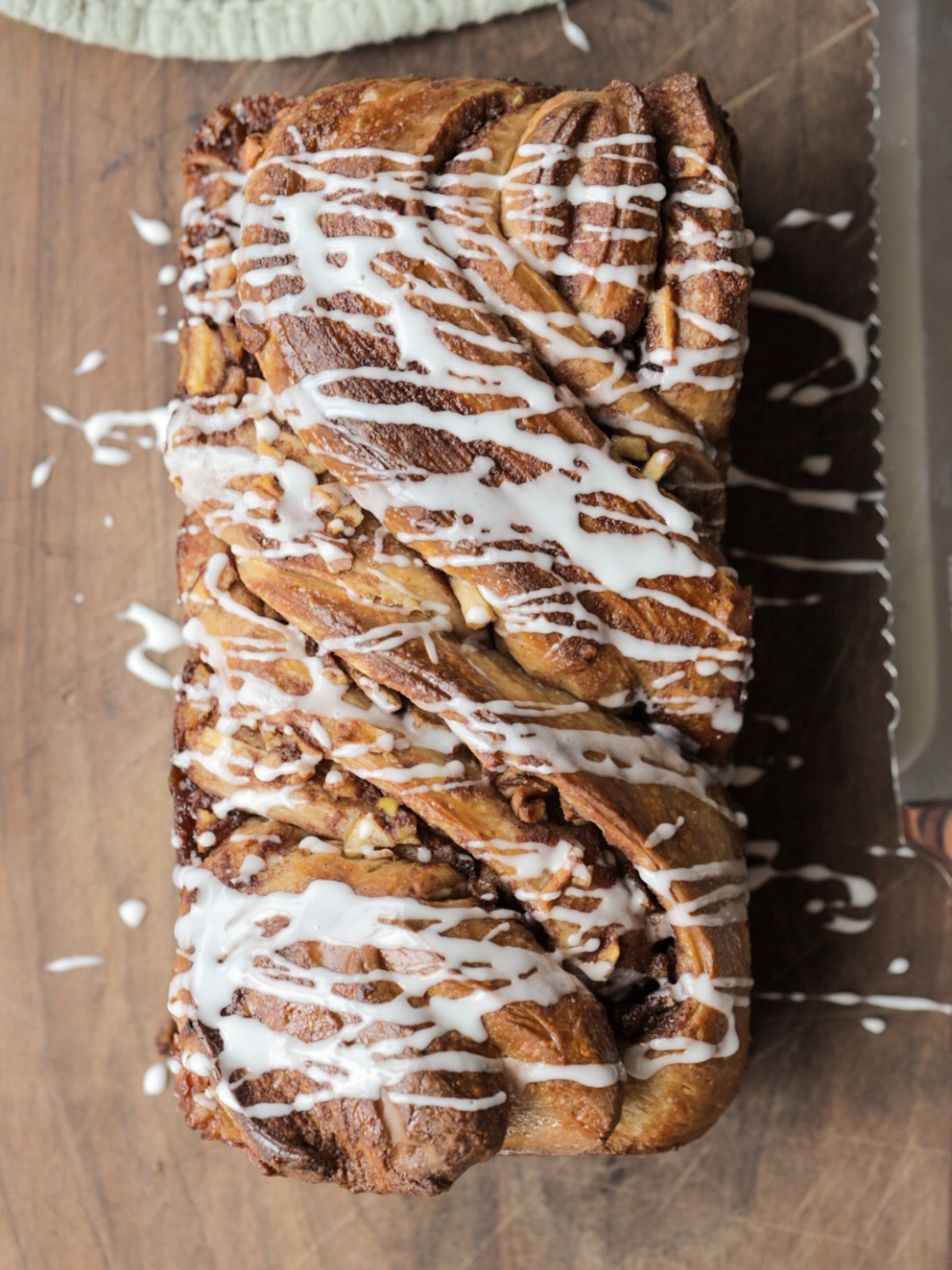 A loaf of sourdough apple-filled babka with vanilla icing drizzled over the top. This sourdough brioche dough is 100% naturally leavened--no yeast!