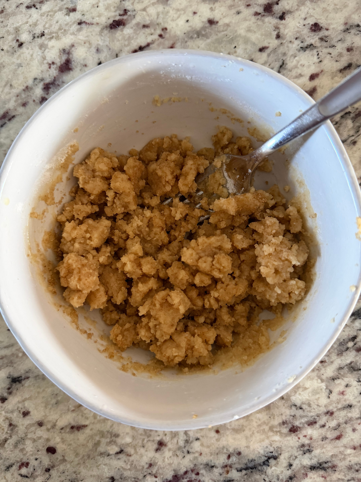 The brown sugar crumble for the apple pie focaccia is shown in a bowl. 