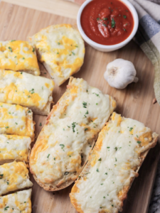 A closeup of the sliced sourdough cheesy garlic bread is shown.